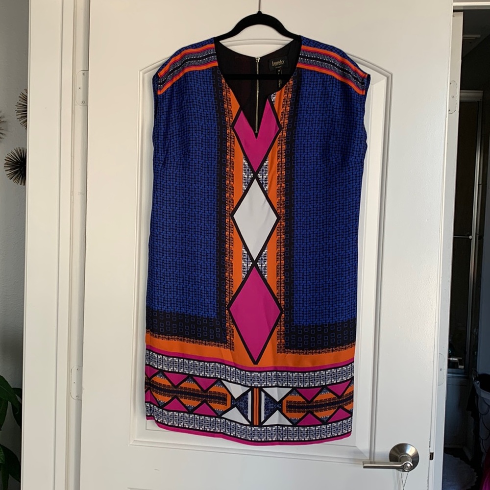 Vibrant color, sleeveless shift dress, exposed zip back.